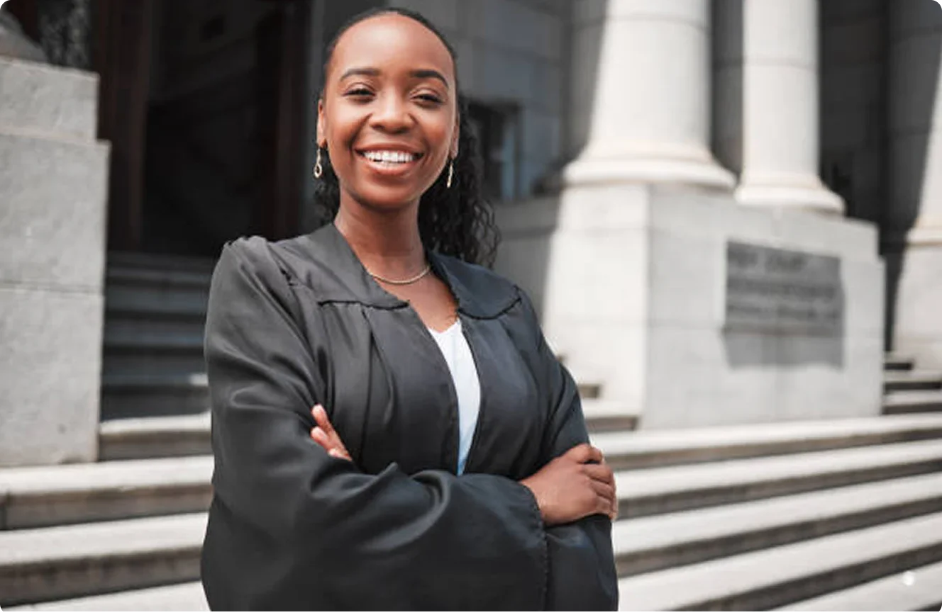 Young black female attorney standing on the stairs outside a court in South Africa