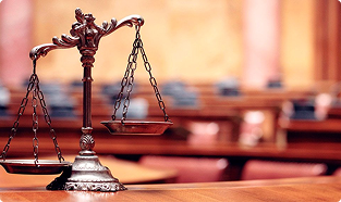 Bronze scales of justice inside a courtroom