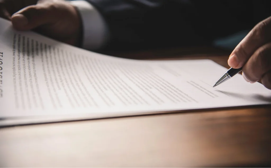 Lawer filling out some legal documentation with a black pen